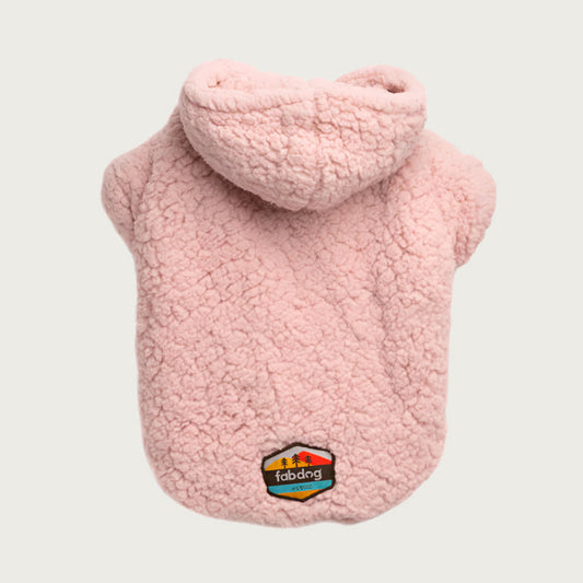 Pale blush pink faux sherpa fleece dog hoodie with short "sleeves", and a fabdog logo at bottom.