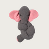 Dark gray, snake-like dog toy with an elephant head with pink inner ears (gray exterior ears) and cute face. Tail end of the toy is tipped in pink, like a snout. Toy is tied in a knot.