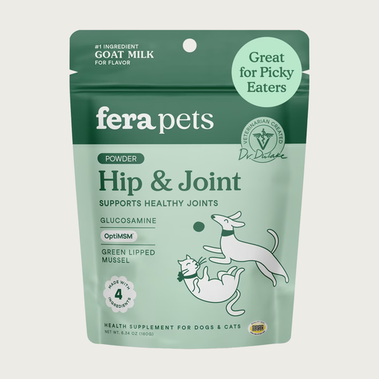 Two-toned green bag of Fera Pets Hip & Joint powder. Veterinarian created. Made with 4 ingredients: goat milk, glucosamine, OptiMSM, and green lipped mussel. Health supplement for dogs & cats. Great for picky eaters. #1 Ingredient-Goat Milk, for Flavor.