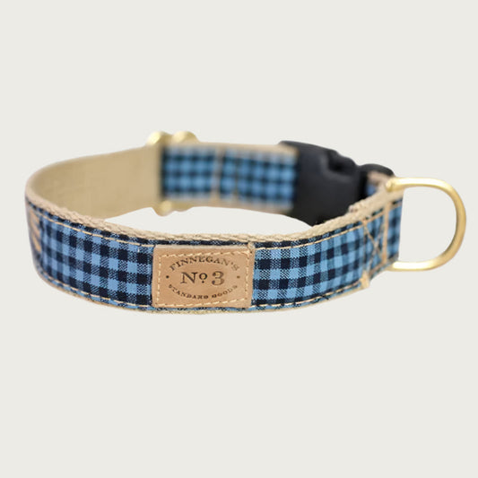 Navy blue and denim blue gingham checkered dog collar with a black plastic buckle and brass D-ring.