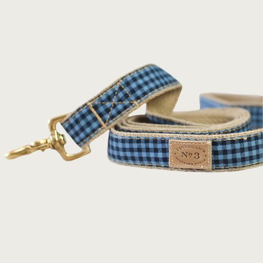 Navy blue and denim blue gingham checkered dog leash with a brass clasp.