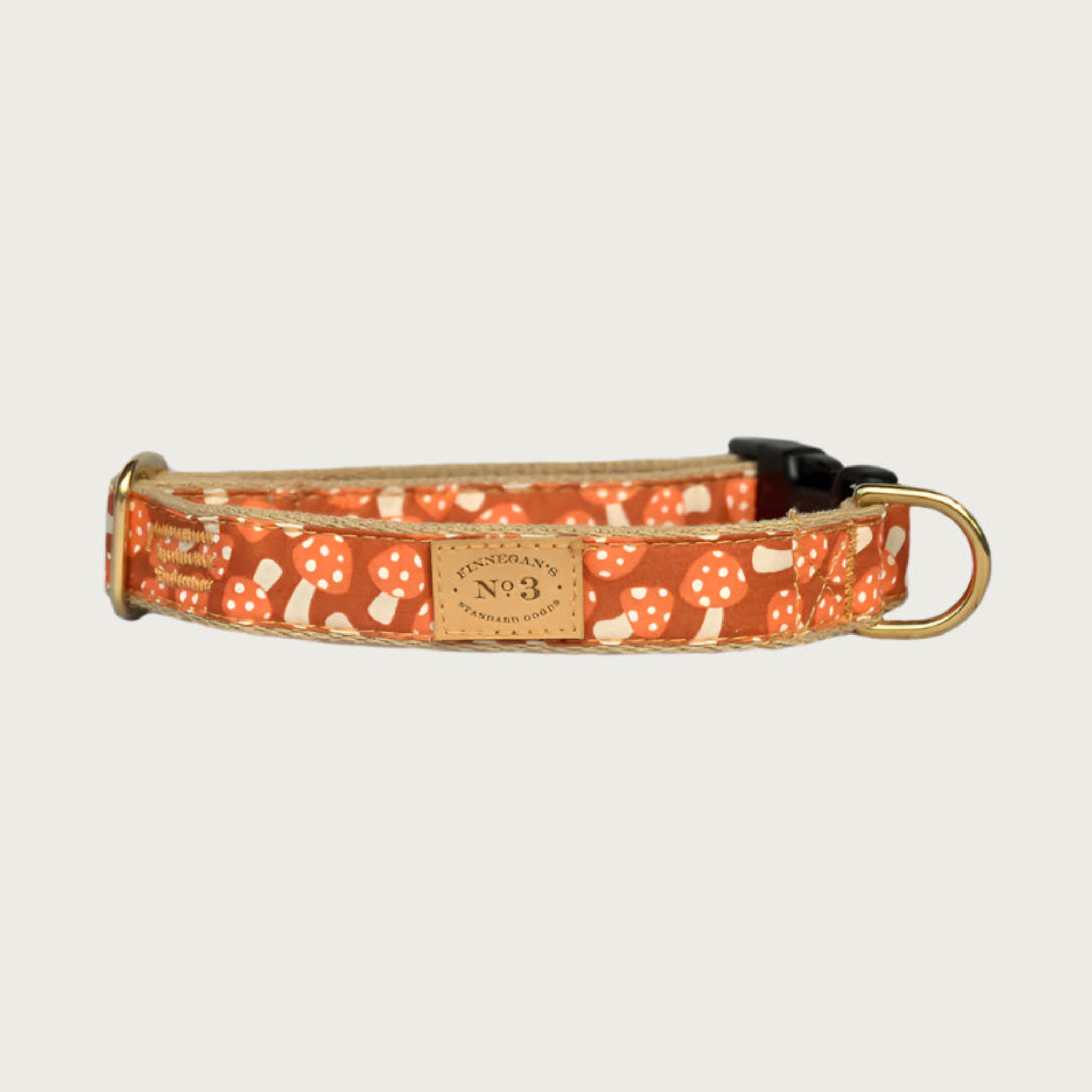Dog collar with burnt orange base color, and orange & cream spotted mushroom pattern.