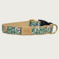 Load image into Gallery viewer, Dog collar with a botanical-themed print, in a base color of hunter green with small pink & white floral details with lighter green leaves. Black plastic buckle and brass D-ring.
