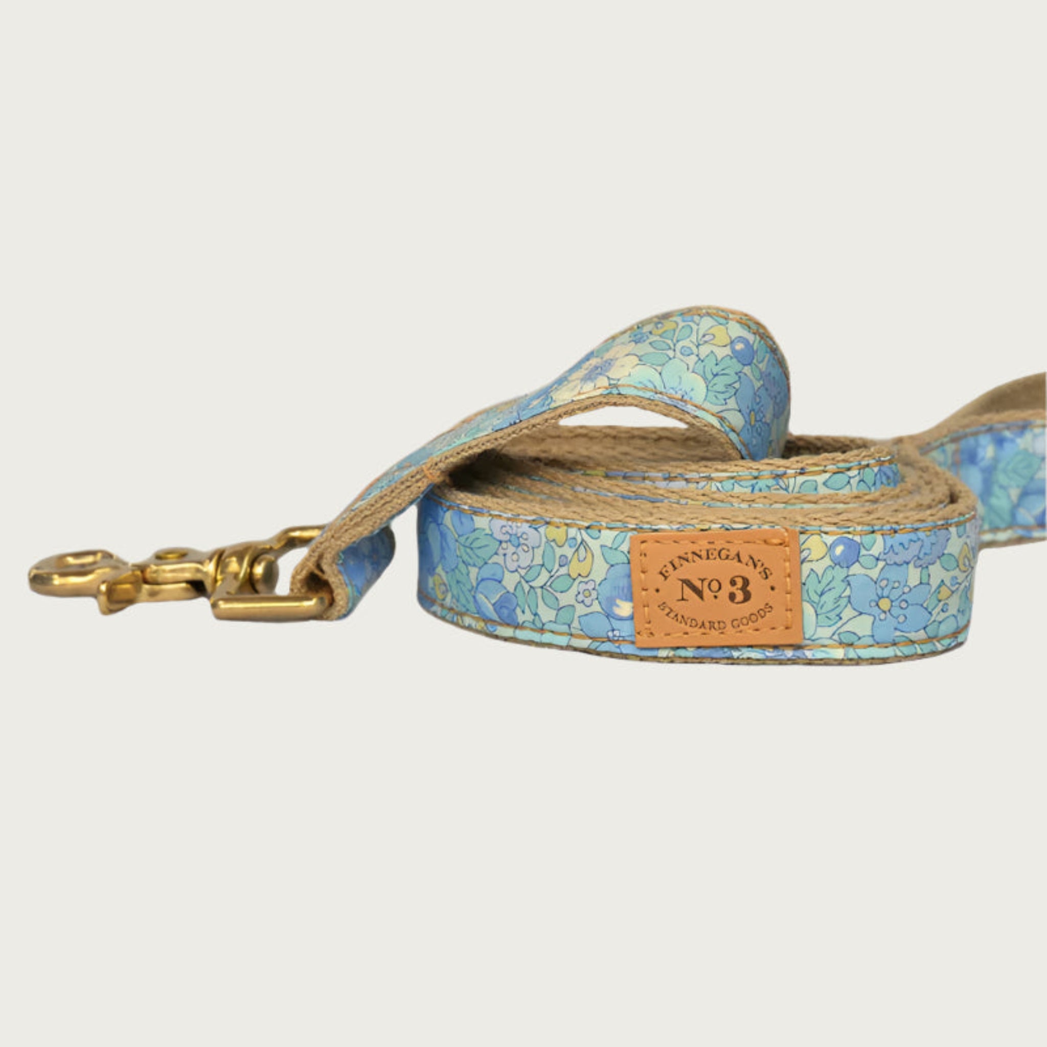Dog collar featuring a subtle floral pattern in shades of pastel blue. Brass clasp.