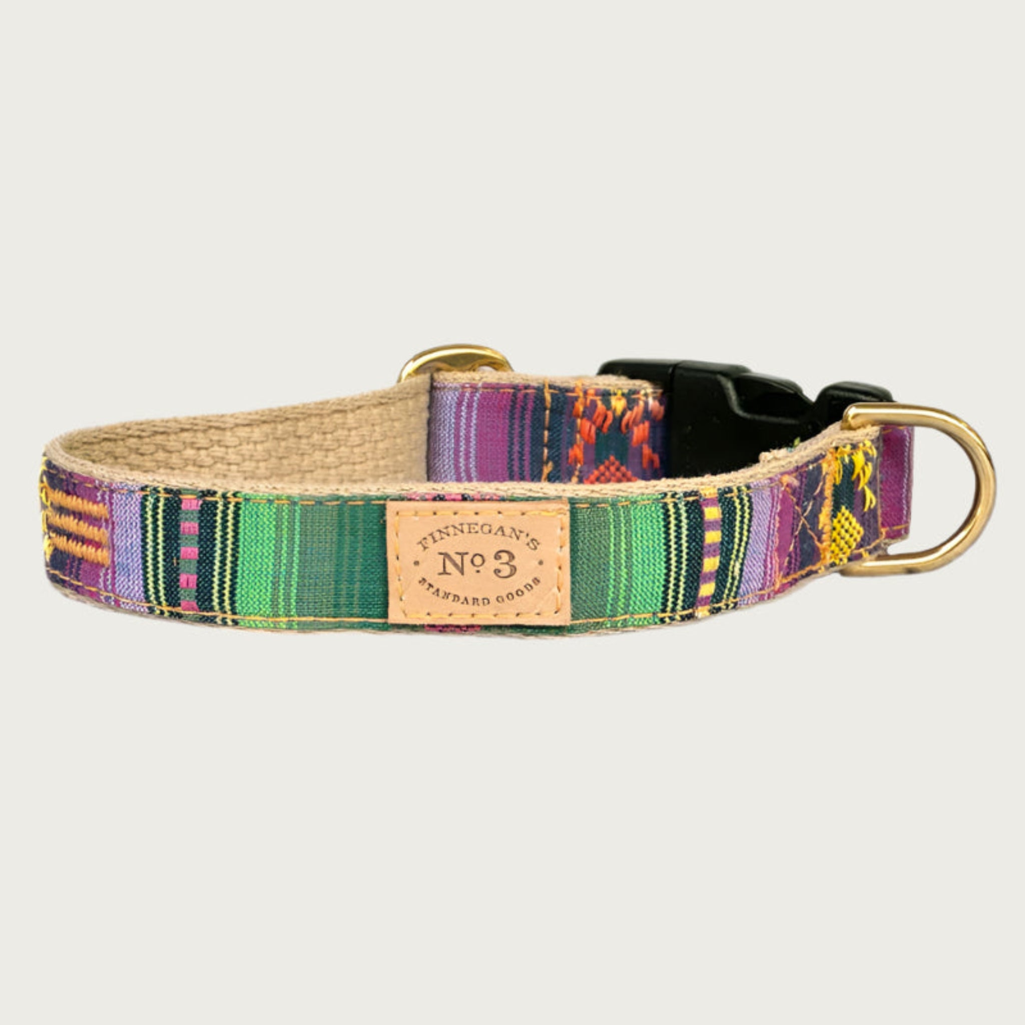 Dog collar with a serape blanket-inspired design, in bright shades of green and purple with yellow, pink, and orange accents.