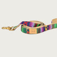 Load image into Gallery viewer, Dog leash with a serape blanket-inspired design, in bright shades of green and purple with yellow, pink, and orange accents.
