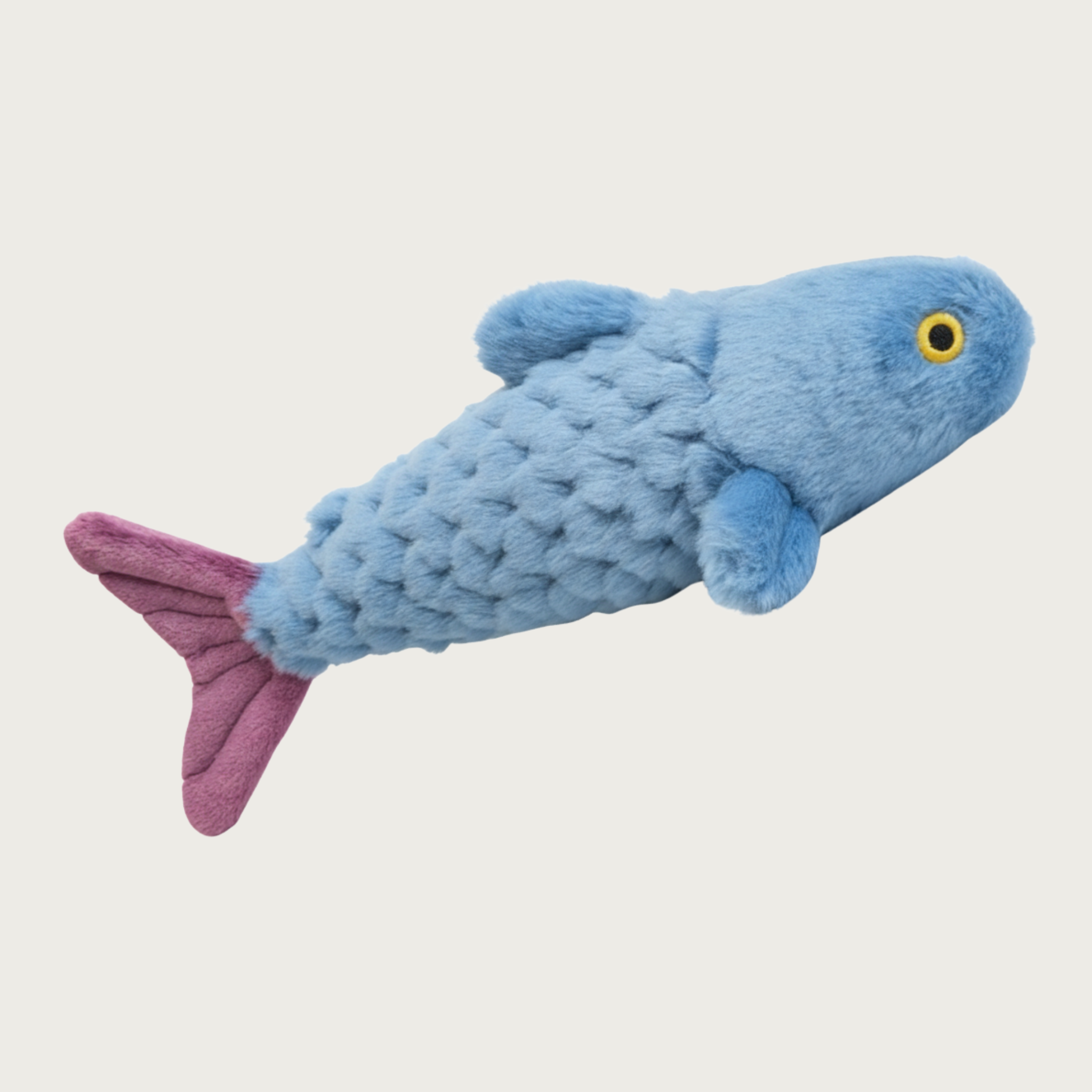A plush fish-shaped dog toy in light blue with a textured scale pattern, medium purple tail, and embroidered yellow & black eyes.