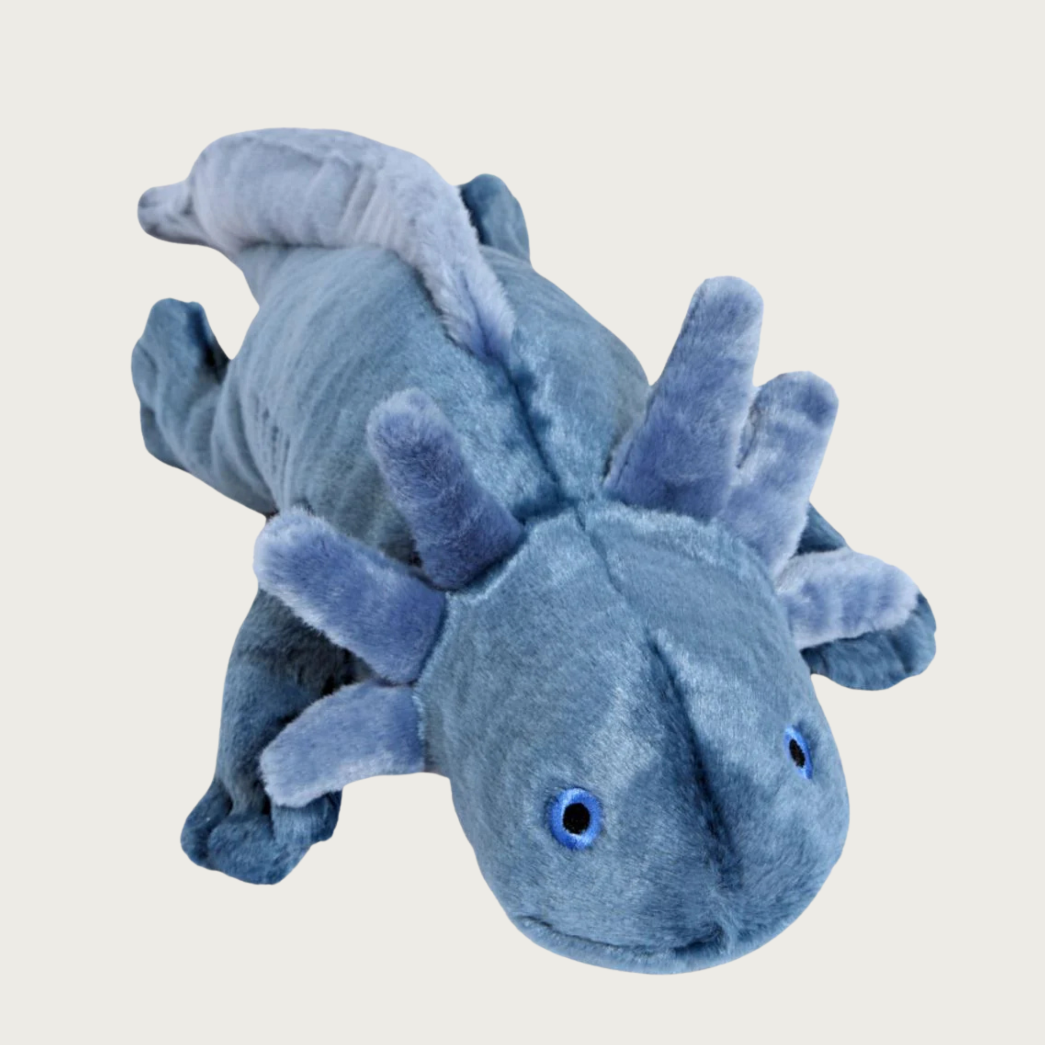 Light navy blue colored axolotl plush dog toy, laying on its stomach with 4 legs outstretched. It has 3 "gills" on each side of its head (looks like antlers or ears), and a long tail that starts on the mid-back.