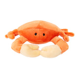 Plush Phyllis Crab dog toy from Fluff & Tuff. Toy has an orange body and eight legs,with pale yellow pincers on its front two legs, and black eyes.