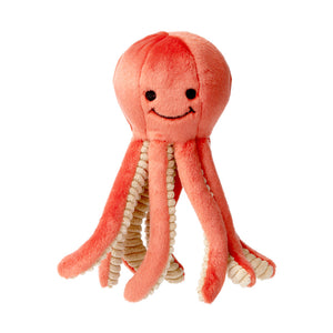 Plush Squirt Octopus dog toy from Fluff & Tuff. Its body is coral colored, with the underside of its legs a light beige with ribbed texture. It has a cute smiley face (eyes & mouth) embroidered in black on its head.