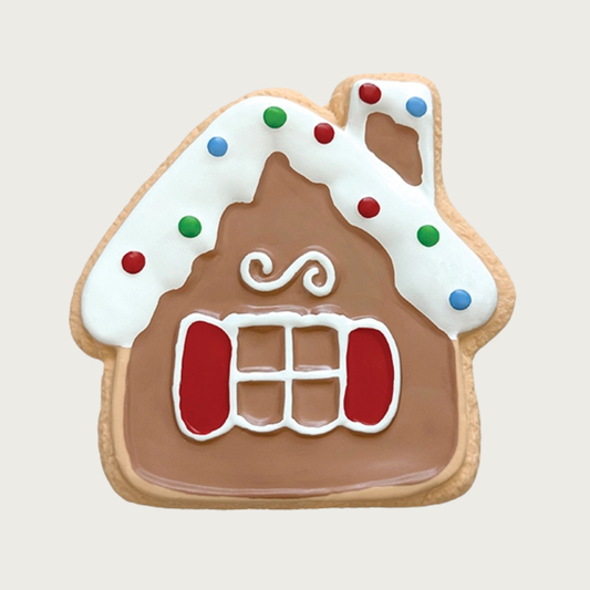 Flat, latex dog toy decorated to look like a sugar cookie. It's shaped like a gingerbread house, with a snow capped roof & chimney with multicolor dots, and window pane with red shutters.