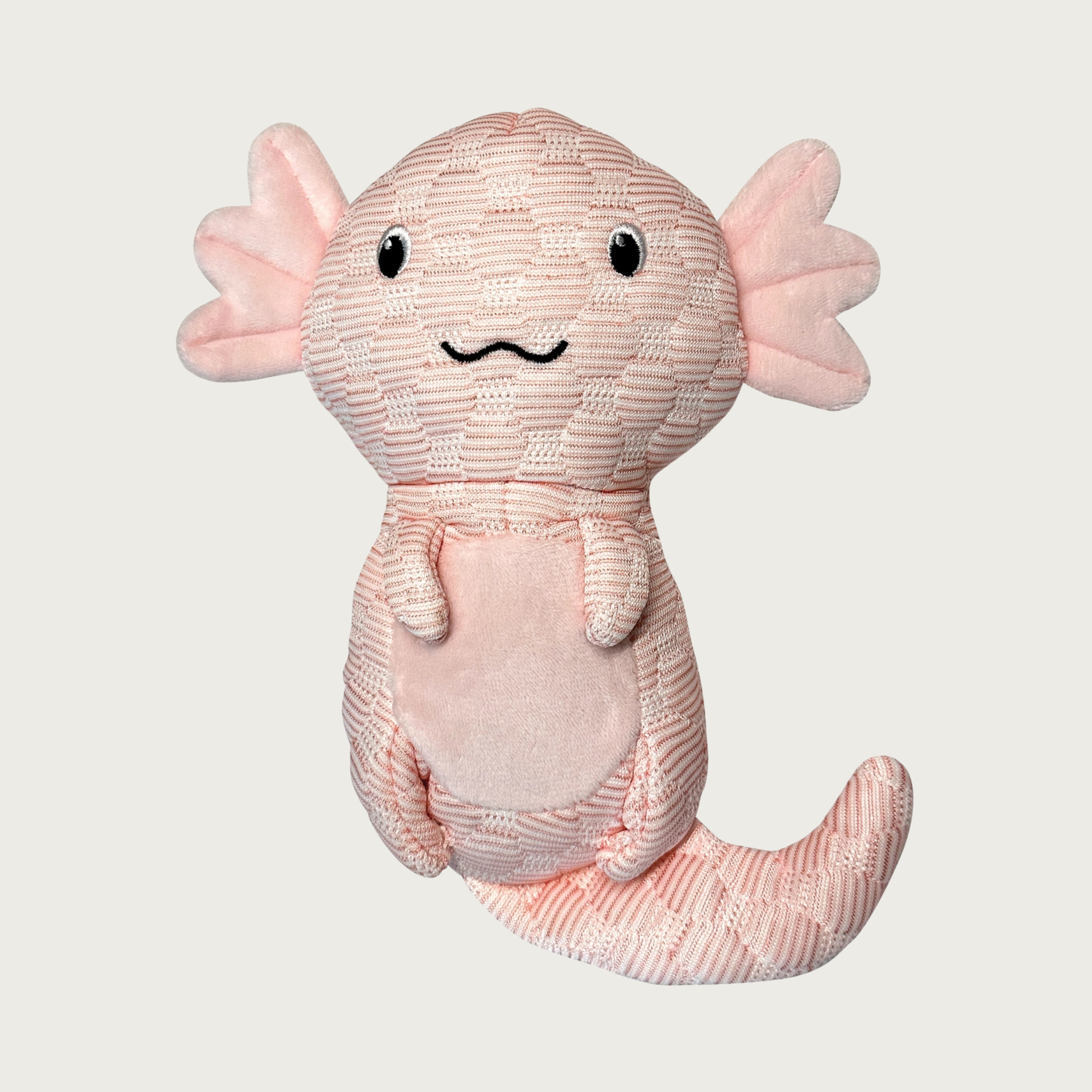 Dog toy shaped like an axolotl salamander, with a pale pink quilted body with and pale pink plush tummy & gills, and embroidered smiley facial expression.