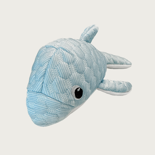 Head-on view of the Puff Plushies Dolphin dog toy. It is pale blue with a puffy, quilted texture, with embroidered eyes.