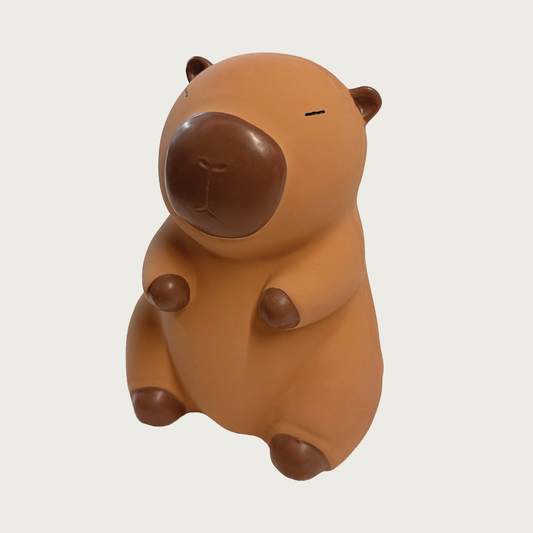 Brown latex dog toy shaped like a capybara sitting on its hind legs.