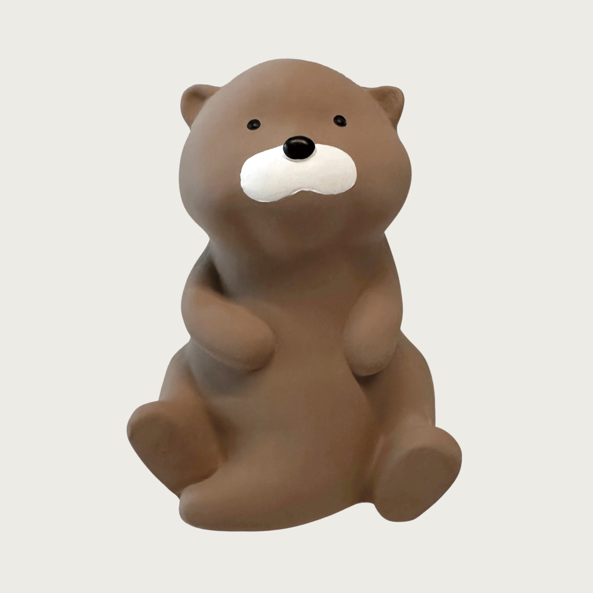 Simply designed, brown latex dog toy shaped like an otter sitting on its hind legs with tail tucked underneath.