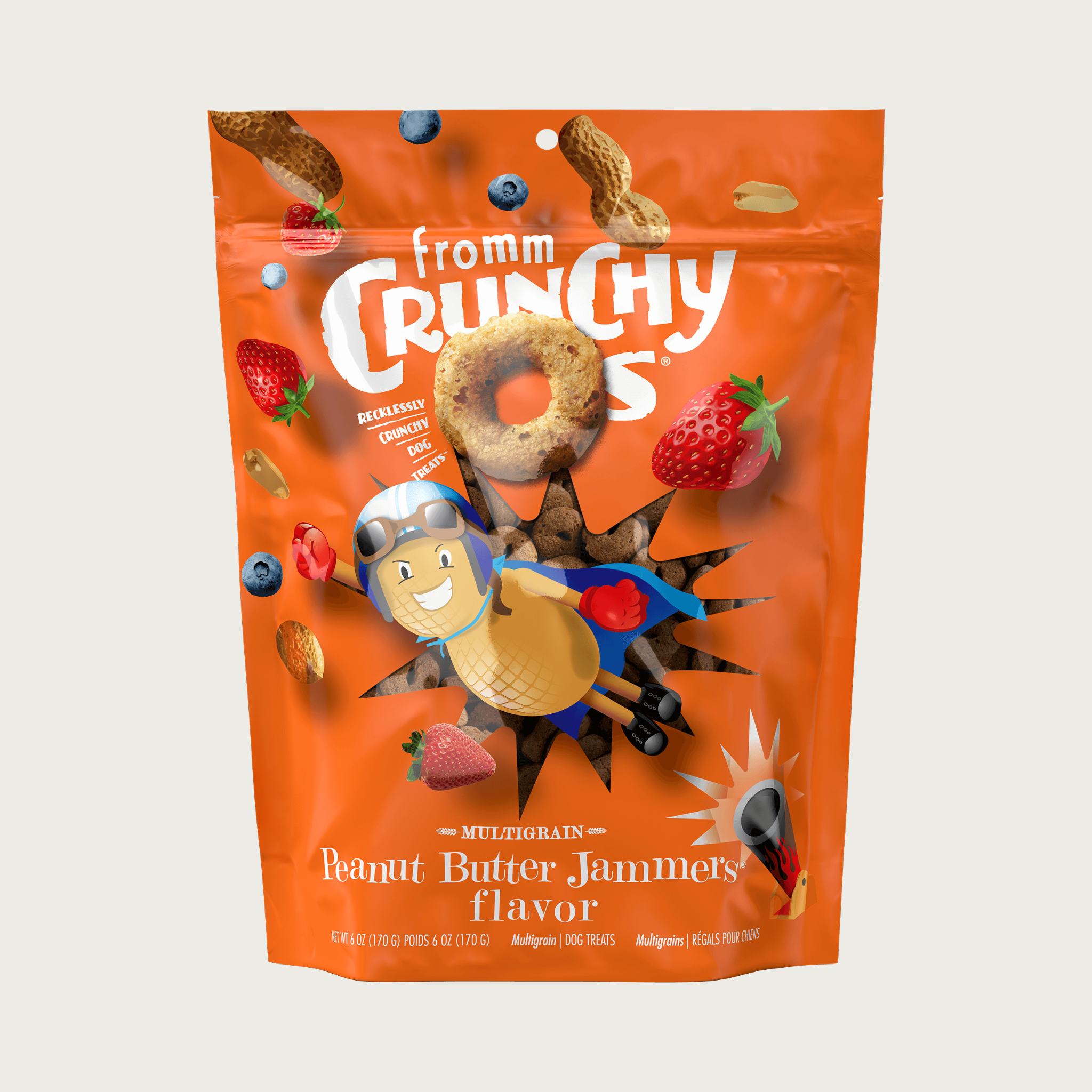A 6 oz orange bag of Fromm Crunchy O's Multigrain Peanut Butter Jammers flavor dog treats. Mini photos of the round ring shaped treats, whole, unshelled peanuts, strawberries and blueberries are featured, along with an illustration of a flying peanut man being shot out of a cannon.