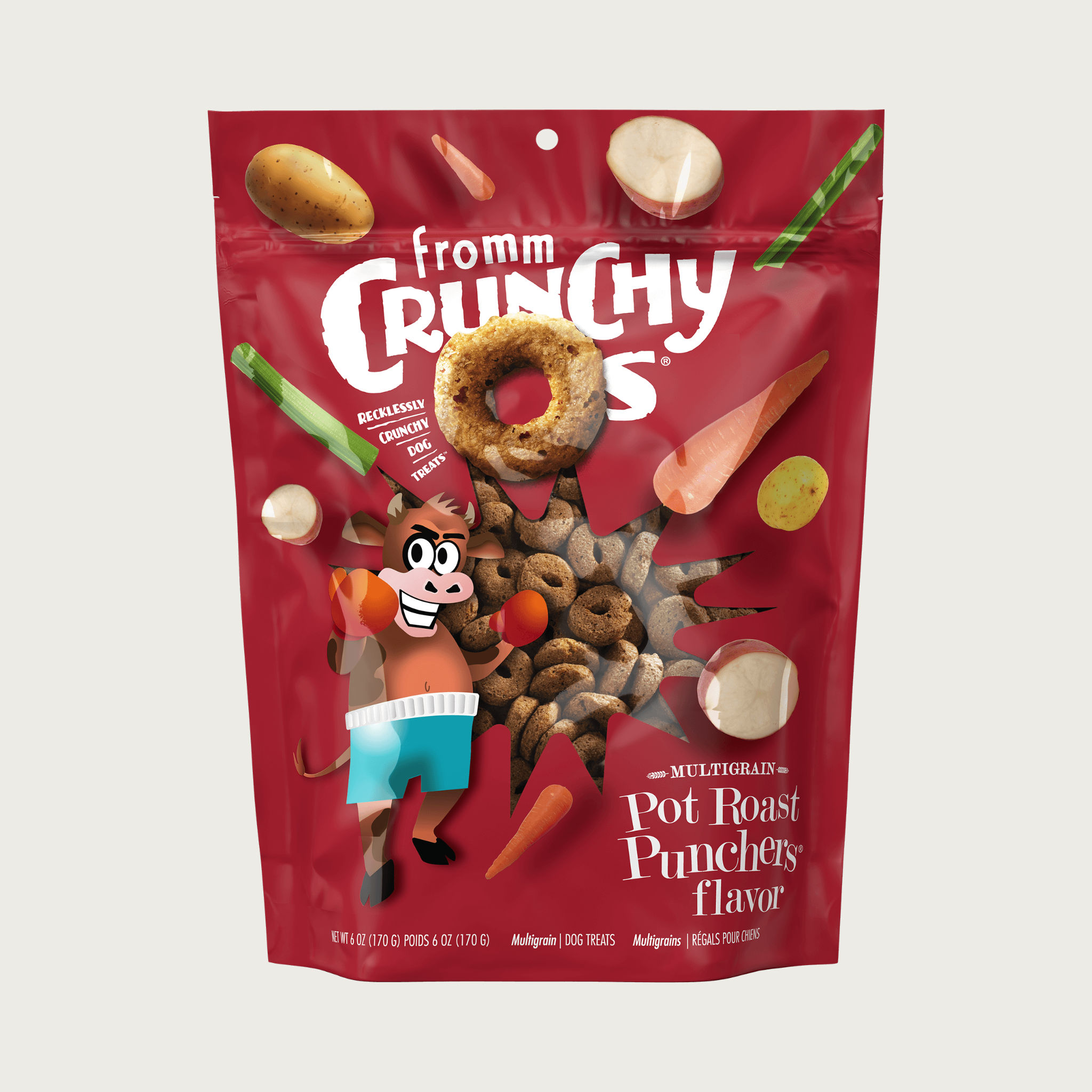 A deep red pouch of Fromm Crunchy O's 'Pot Roast Punchers' flavor dog treats, featuring cartoon graphics of a cow wearing boxing gear and vegetables, with a clear window showing the treats inside.