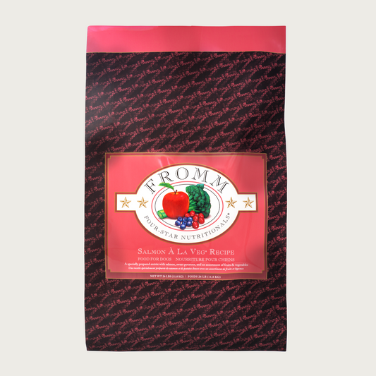 A 26 pound black and coral bag of Fromm Salmon A La Veg Recipe dog food.