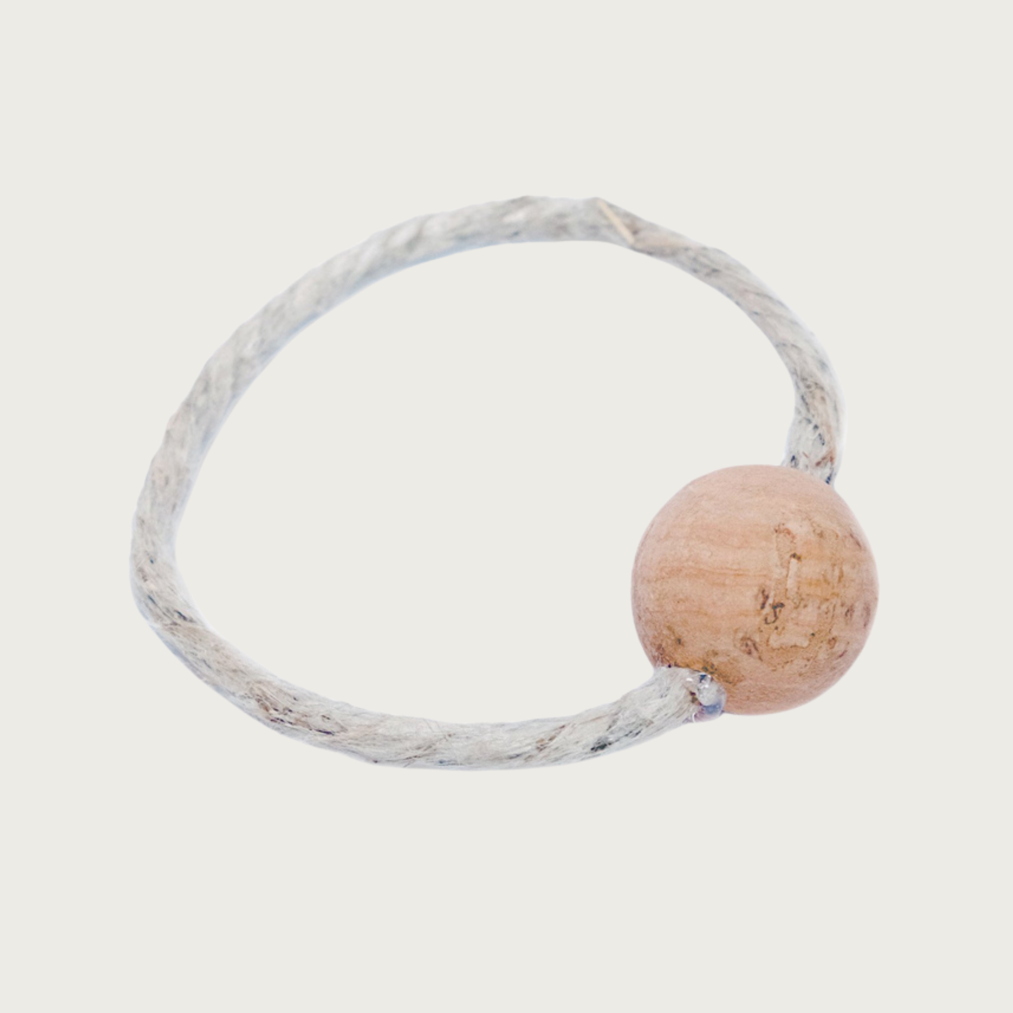 Natural colored hemp loop cat toy that goes through a cork ball.