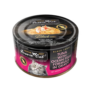 2.82 oz black & hot pink can of Fussie Cat Black Label Tuna with Ocean Fish Formula in Gravy. Complete and balanced diet for all life stages. Fortified with vitamins and minerals. So tasty your cat can't resist! Small photo on top of can shows product inside - flakes and shreds of tuna and ocean fish in gravy.