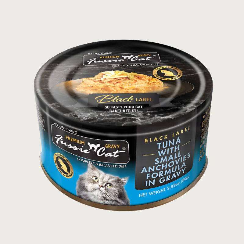 2.82 oz black & blue can of Fussie Cat Black Label Tuna with Small Anchovies Formula in Gravy. Complete and balanced diet for all life stages. Fortified with vitamins and minerals. So tasty your cat can't resist! Small photo on top of can shows product inside - flakes of tuna and small, whole anchovies in gravy.
