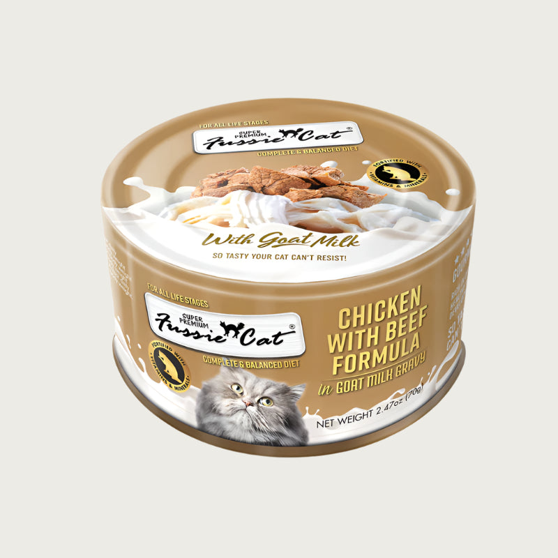 A 2.47 oz tan can of Fussie Cat Chicken with Beef Formula in Goat Milk Gravy cat food. Super premium, for all life stages - "so tasty your cat can't resist!" Image on top of can shows flaked and shredded chicken and beef.