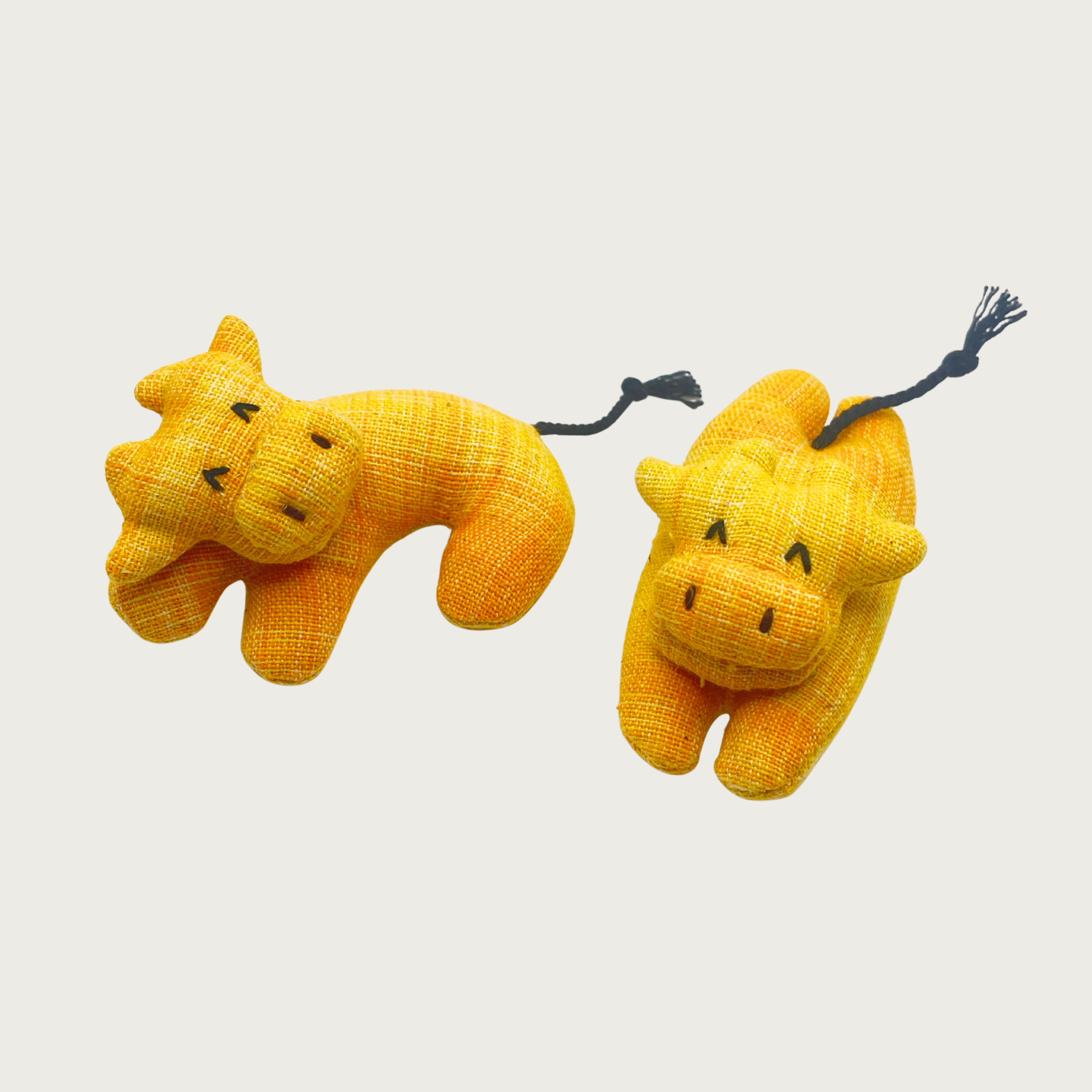 Two Holy Cow cat toys in bright yellow, side by side showing the available shapes: curved or laying flat.