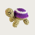 Load image into Gallery viewer, Crocheted Lil' Turtle cat toy with a tan body and a purple shell featuring a white circle and embroidered eyes & mouth.
