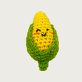 Load image into Gallery viewer, A crocheted cat toy shaped like a corn cob, featuring a bright yellow textured body and green outer husk, with an embroidered smiling face.
