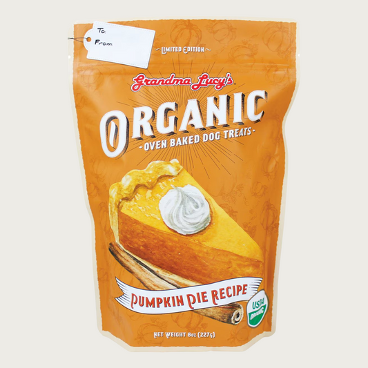 Orange bag of Limited Edition Grandma Lucy's Organic Oven Baked Dog Treats Pumpkin Pie Recipe with large, illustrated slice of pumpkin pie in center of bag. USDA Organic.