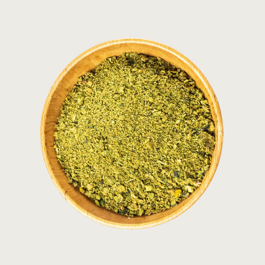 Wooden bowl filled with freeze dried Bailey's Blend-coarsely chopped, greenish-yellow veggie flakes.