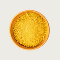 Load image into Gallery viewer, Wooden bowl filled with freeze dried Golden Blend-coarsely chopped, orange-yellow veggie flakes.
