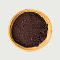 Load image into Gallery viewer, Wooden bowl filled with freeze dried Vitality Blend-finely chopped, deep brownish-purple veggie flakes.
