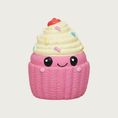 Load image into Gallery viewer, Mini latex cupcake dog toy. It has a bubblegum pink base with white frosting on top. It has multi-colored sprinkles on the frosting, with a red cherry on top, and sweet, simple, smiley face in black, centered on the front.
