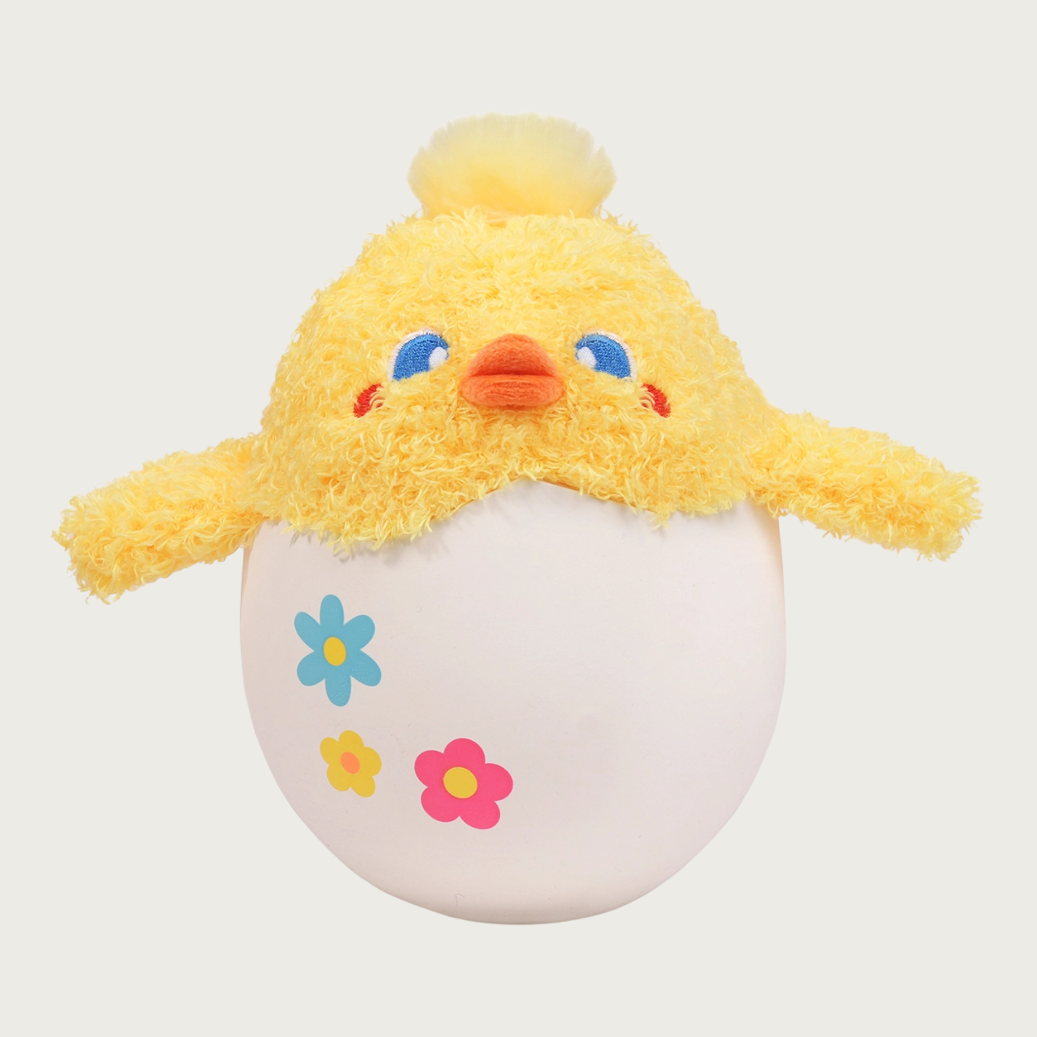 2-in-1 dog toy that resembles a hatching chick. A plush, pale yellow chick toy is sticking out of a "cracked" latex eggshell. 