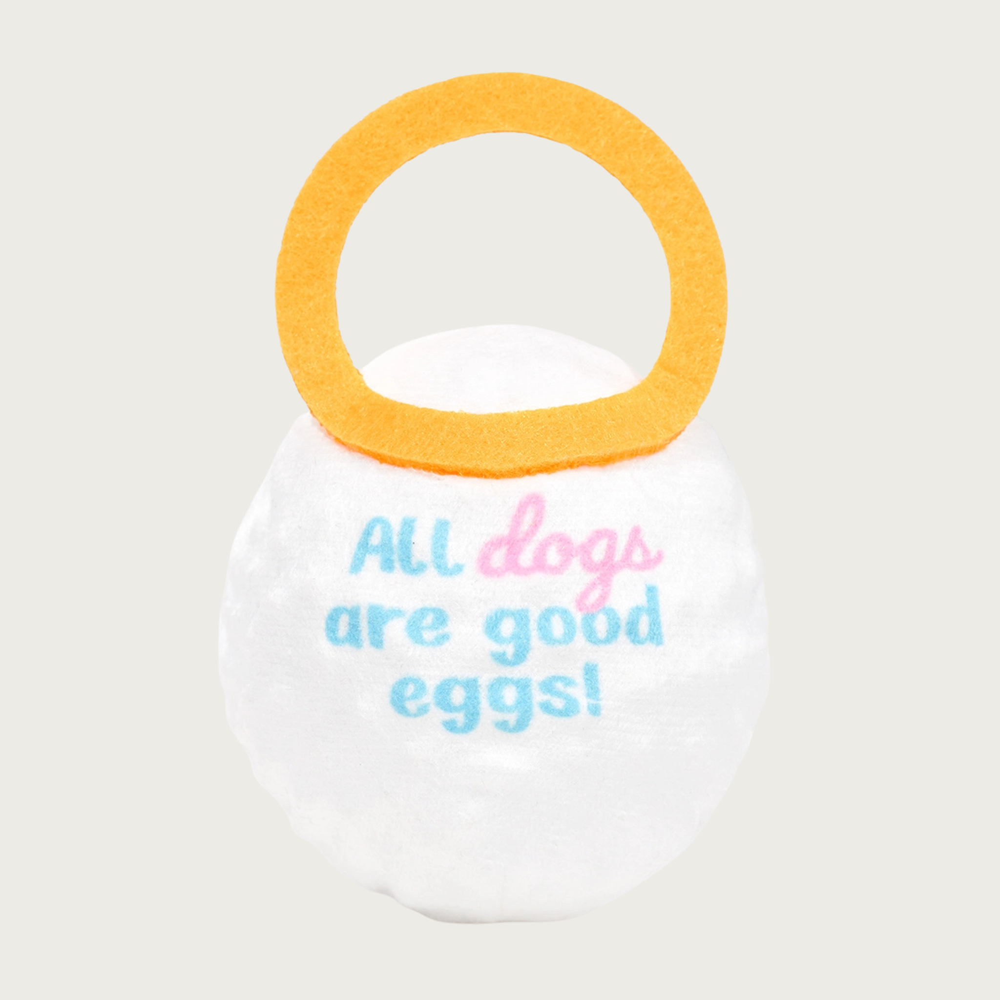 Back of the Good Egg toy. It has pale pink and blue text in the center that reads "All dogs are good eggs!"