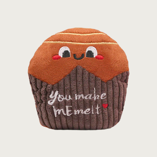 Plush dog toy that looks like a round chocolate candy in a brown wrapper. The candy has a smiling embroidered face, and text on the body (wrapper) reads "You make me melt."