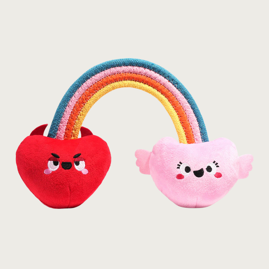 Flat, stitched cotton rope rainbow shaped dog toy with plush red "naughty" heart on one end, and a plush pink "nice" heart on the other. Both have appropriate embroidered facial expressions (frown & smile).