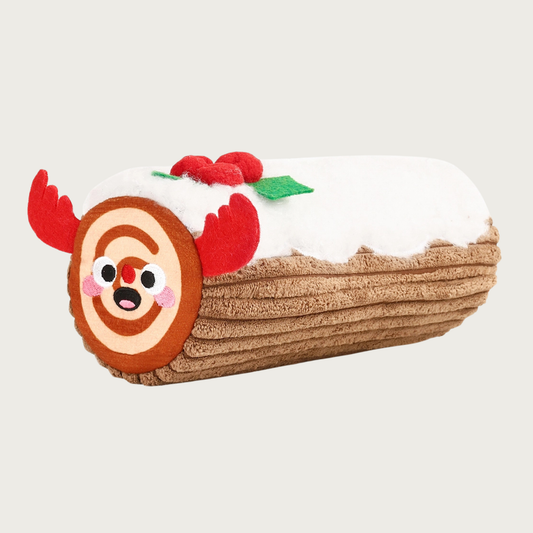 Christmas-themed, plush dog toy shaped like a Yule Log cake with reindeer antlers and smiley face on the end. It's topped with white plush and accented with felt holly.