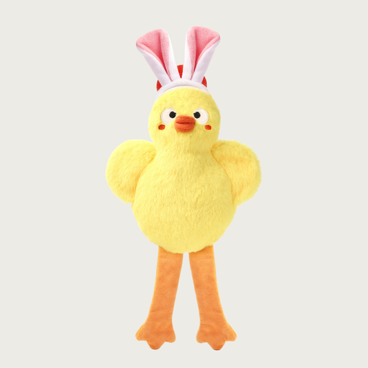 Yellow plush dog toy that resembles a chick wearing bunny ears. It has long orange legs.