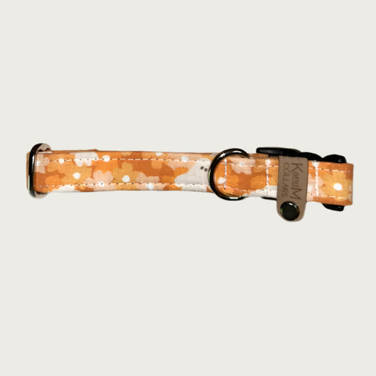 0.75in width, dog collar with floral pattern in shades of orange, with white ghosts, stainless d-ring and black plastic buckle.