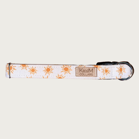 1" wide dog collar with orange geometric suns on a white background