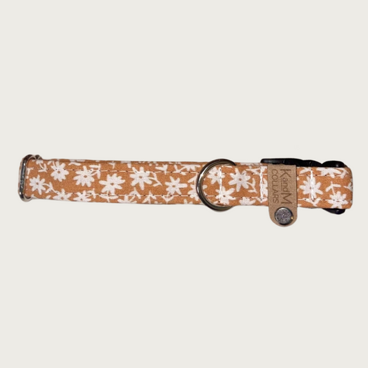 0.75" width dog collar, featuring a tiny floral print in cream, on a light brownish-orange background.