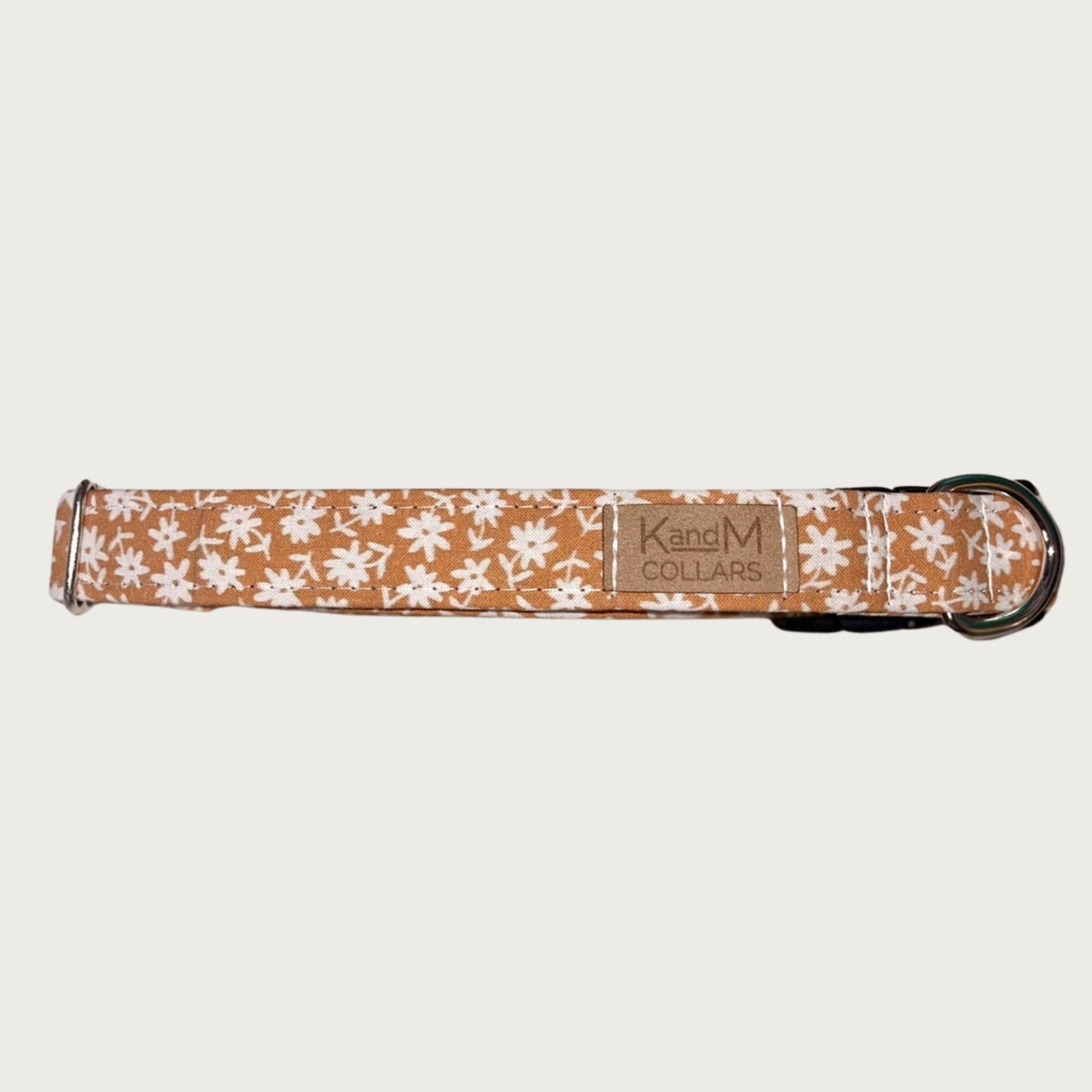 1" width dog collar, featuring a tiny floral print in cream, on a light brownish-orange background.