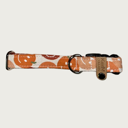 0.75" width dog collar featuring pumpkins in various shades of orange, each with a classic smiley face.