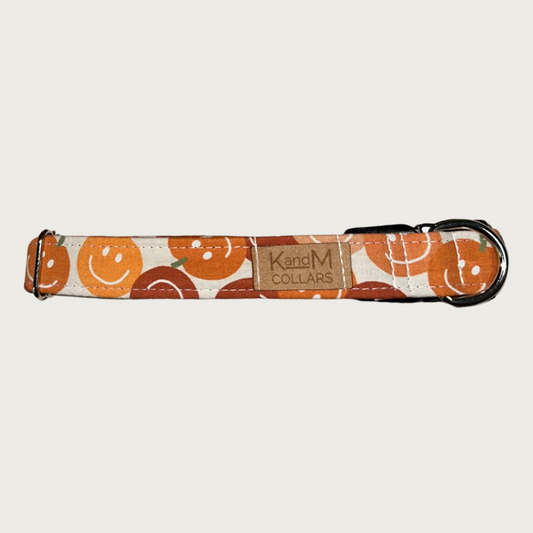 1" width dog collar featuring pumpkins in various shades of orange, each with a classic smiley face.