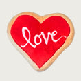 Load image into Gallery viewer, Valentine's Day themed, plush dog toy. Looks like a red "frosted" heart-shaped sugar cookie with 'love' in white script text.
