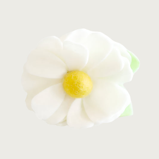 Cream felt collar flower with a yellow center and green leaf.