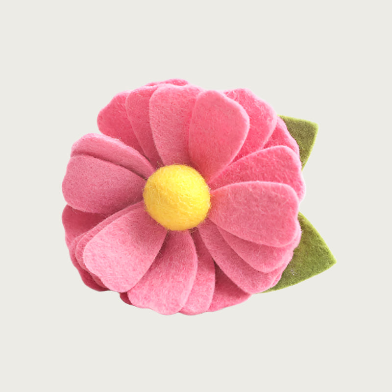 Salmon pink felt collar flower with a yellow center and green leaf.