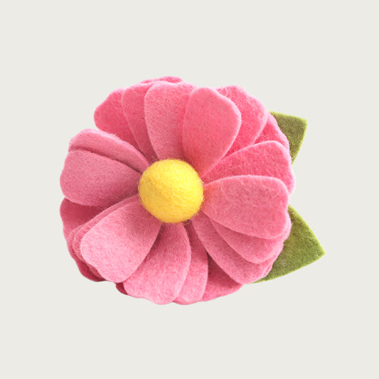 Salmon pink felt collar flower with a yellow center and green leaf.